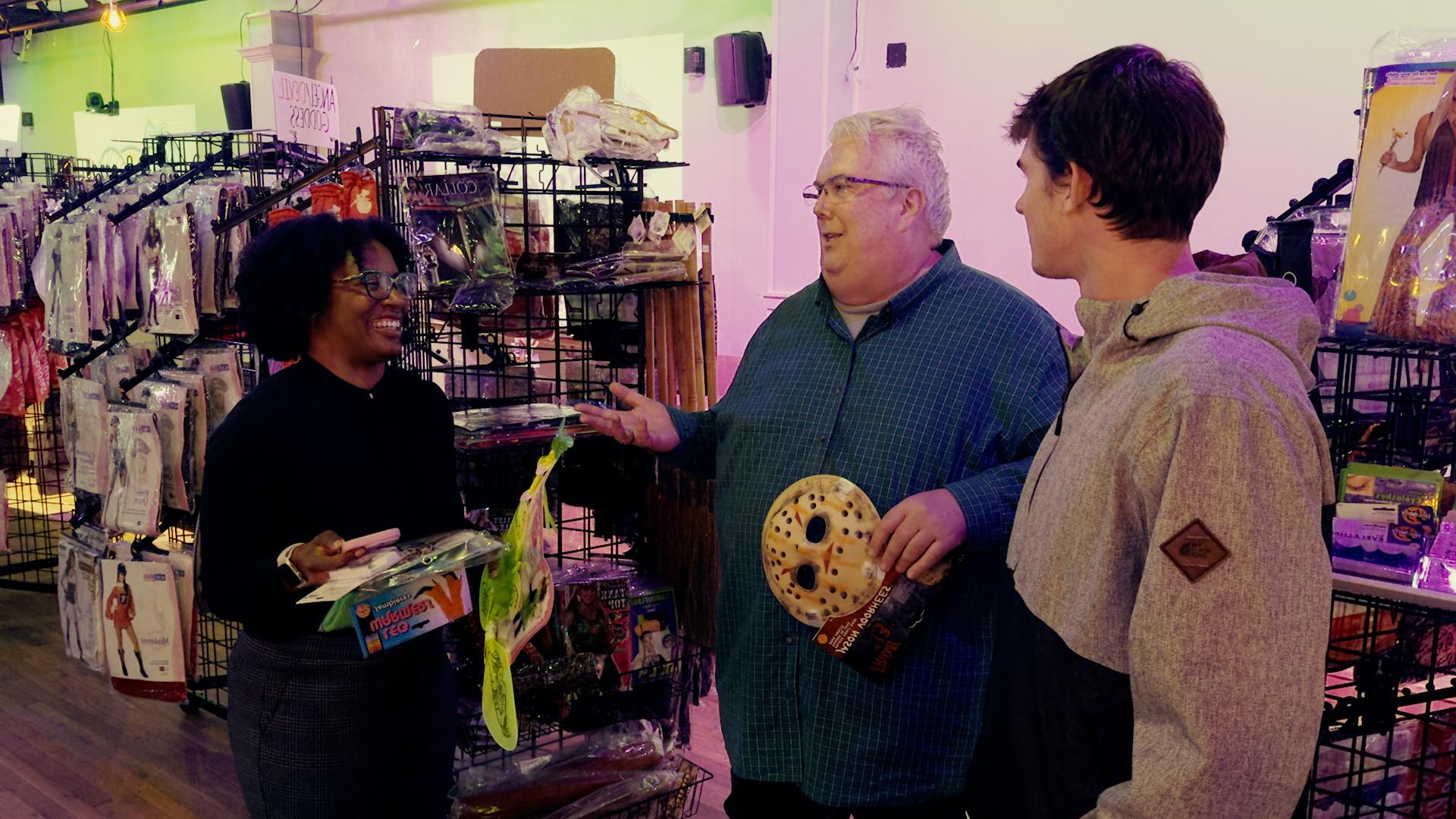 Professor Tim Flood talks with students inside the Heel-O-Ween pop-up store