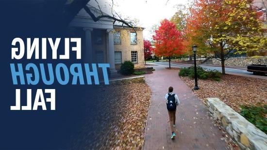 Drone-captured image of a Carolina community member, Brennan Doherty, walking through fall foliage on the campus of UNC-Chapel Hill.